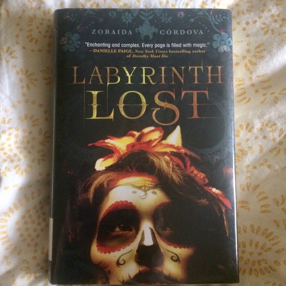 Cover of the book Labyrinth Lost by Zoraida Cordova on a white background with tiny yellow flowers